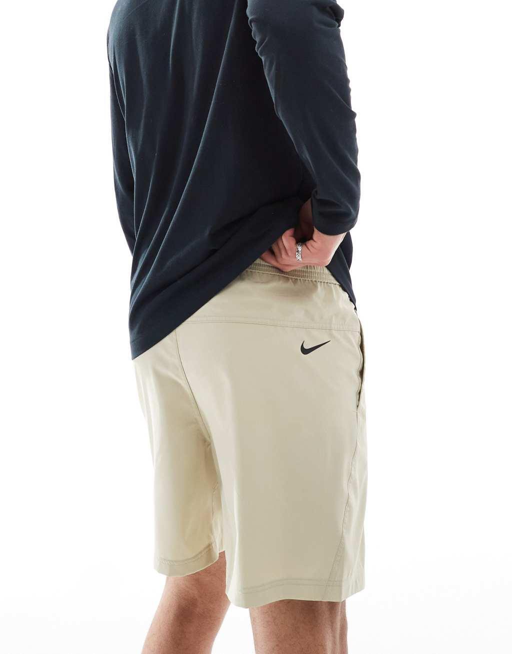 Nike Training blurred swoosh graphic 7 inch shorts in beige Product Image