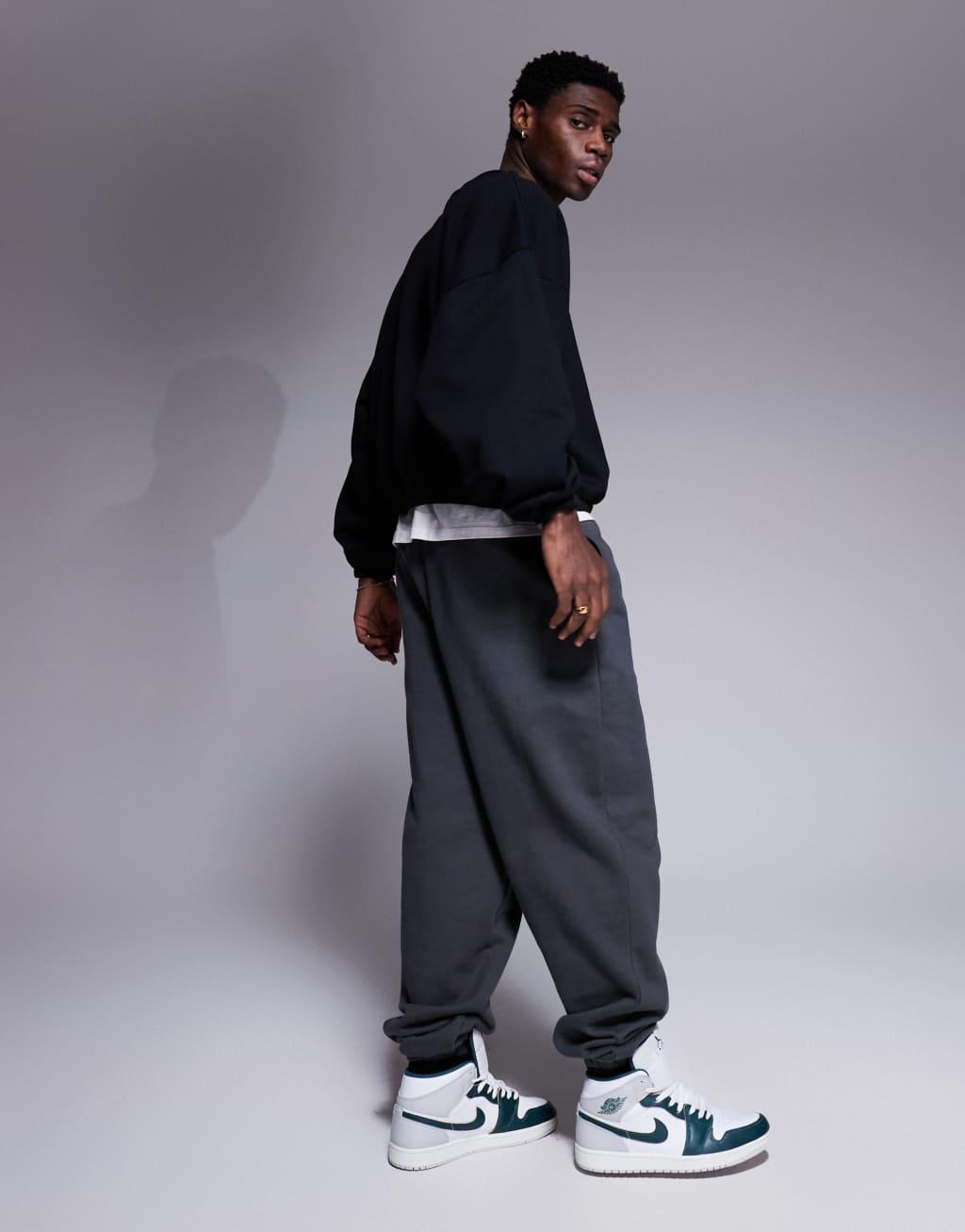 ASOS DESIGN heavyweight boxy extreme oversized sweatshirt with elasticized cuffs and hem in black Product Image