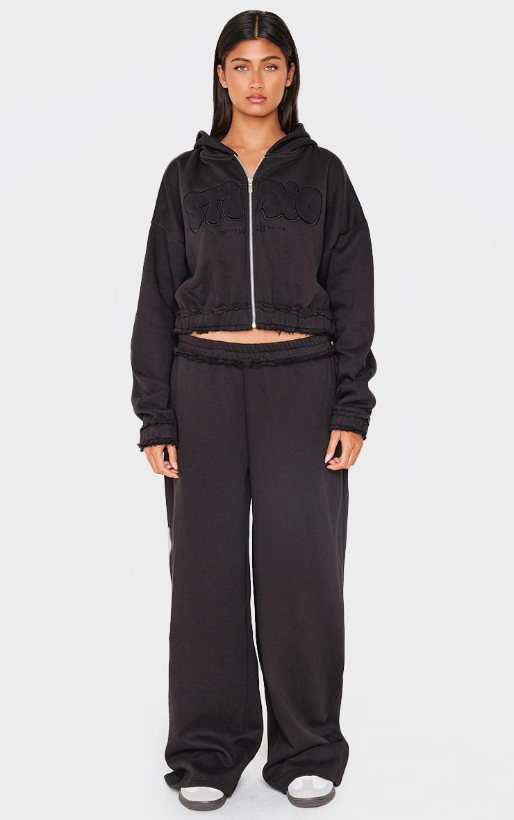 PRETTYLITTLETHING Black Studio Embroidered Raw Hem Detail Zip Up Hoodie Product Image