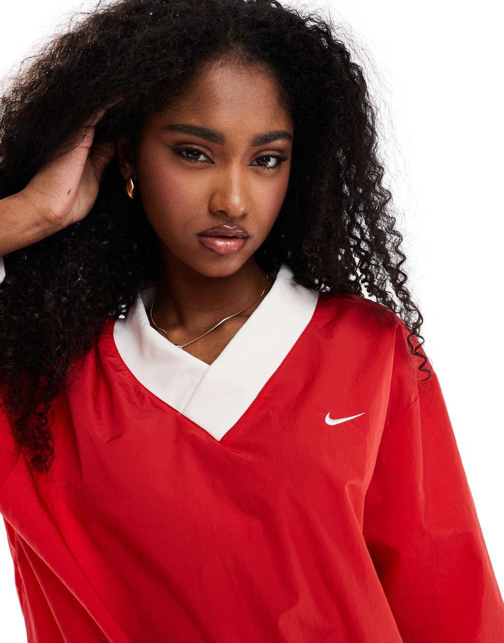 Nike Essential woven v-neck sweatshirt in red Product Image