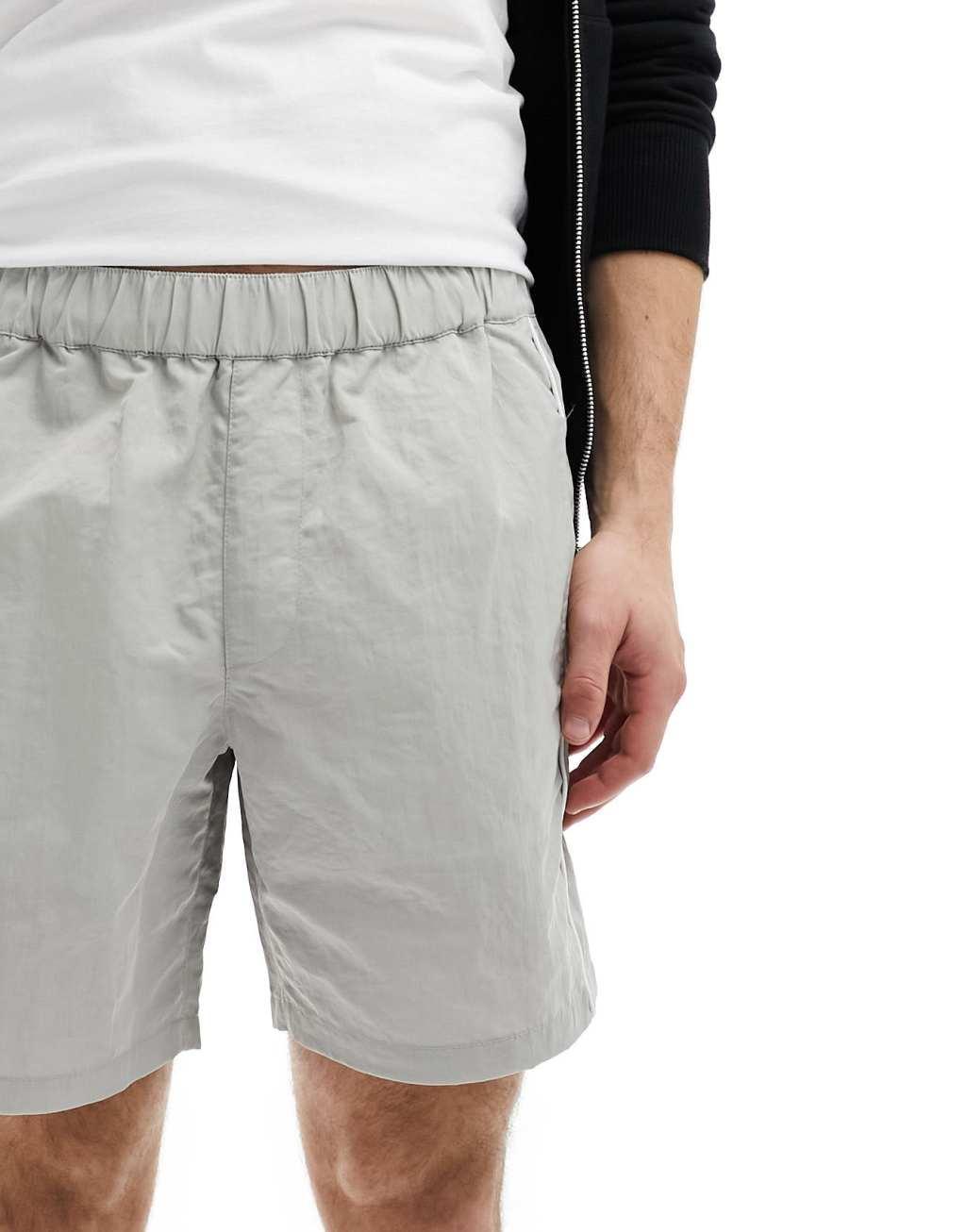 ASOS DESIGN slim nylon shorts with piping detail in stone Product Image