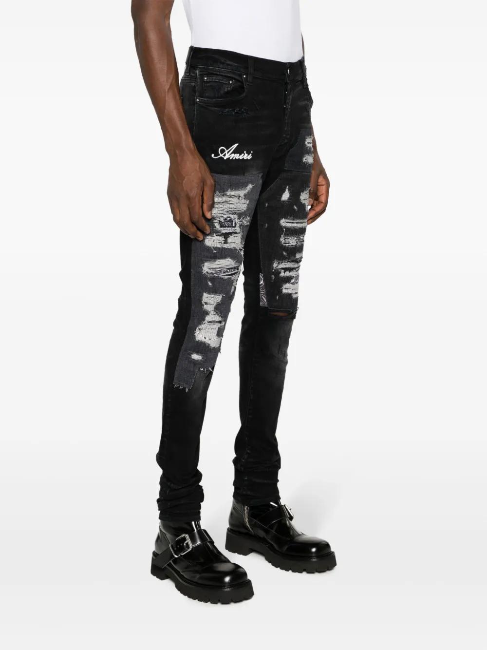 Artisanal distressed slim-fit jeans Product Image