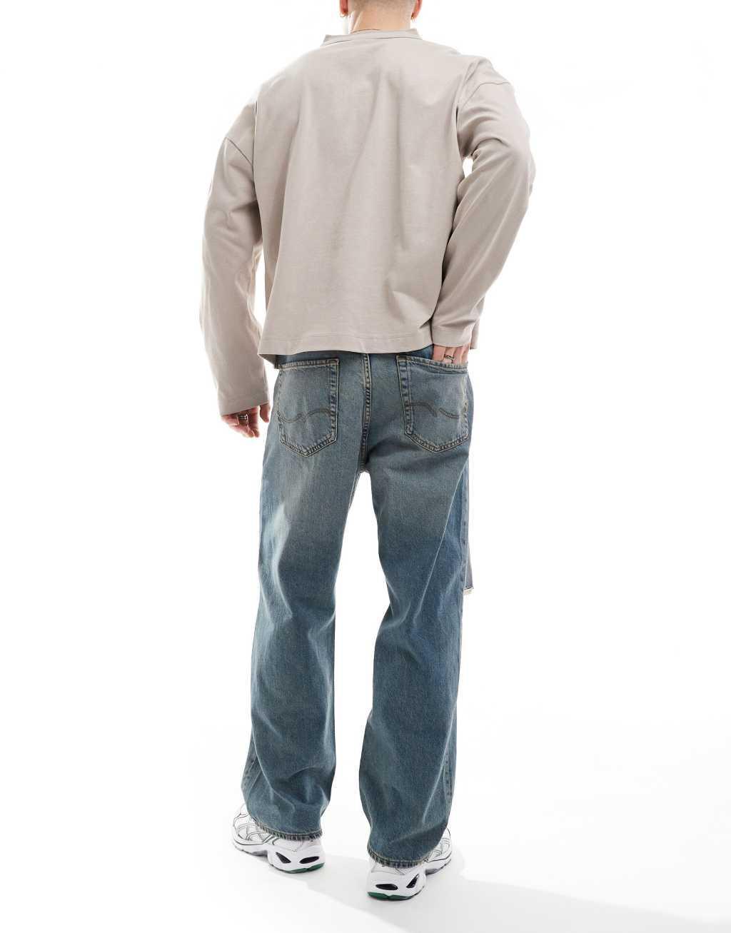Jack & Jones Alex baggy fit jeans with knee rip in blue Product Image