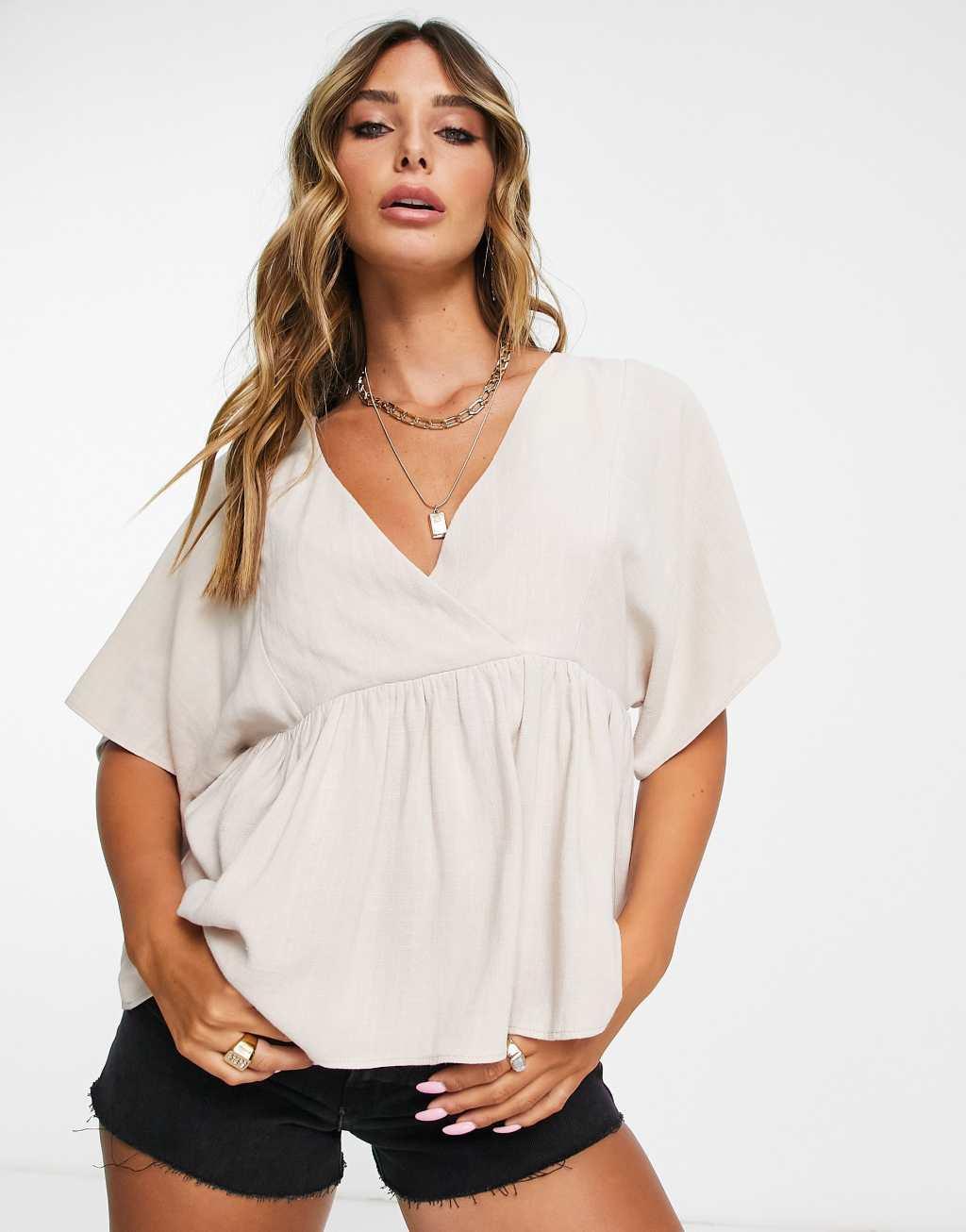 ASOS DESIGN wrap top with angel sleeve & peplum hem Product Image