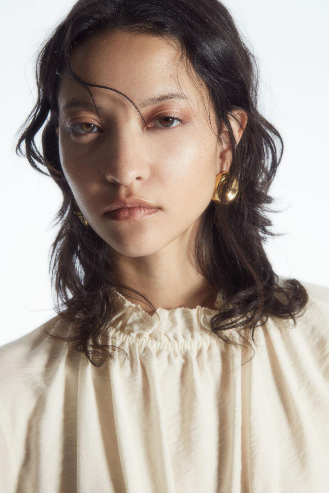 RUFFLED HIGH-NECK BLOUSE Product Image