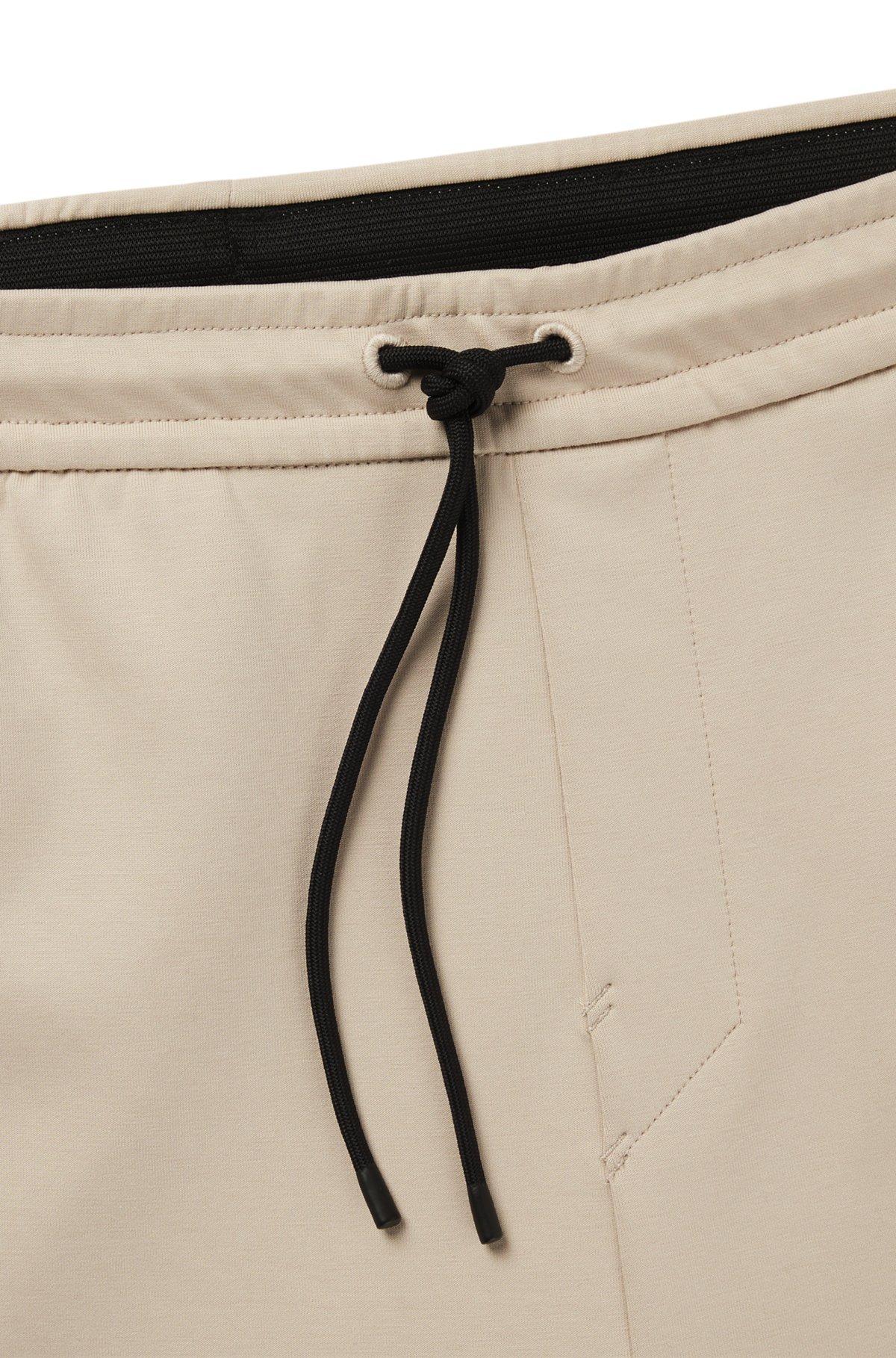 Stretch tracksuit bottoms with logo patch Product Image