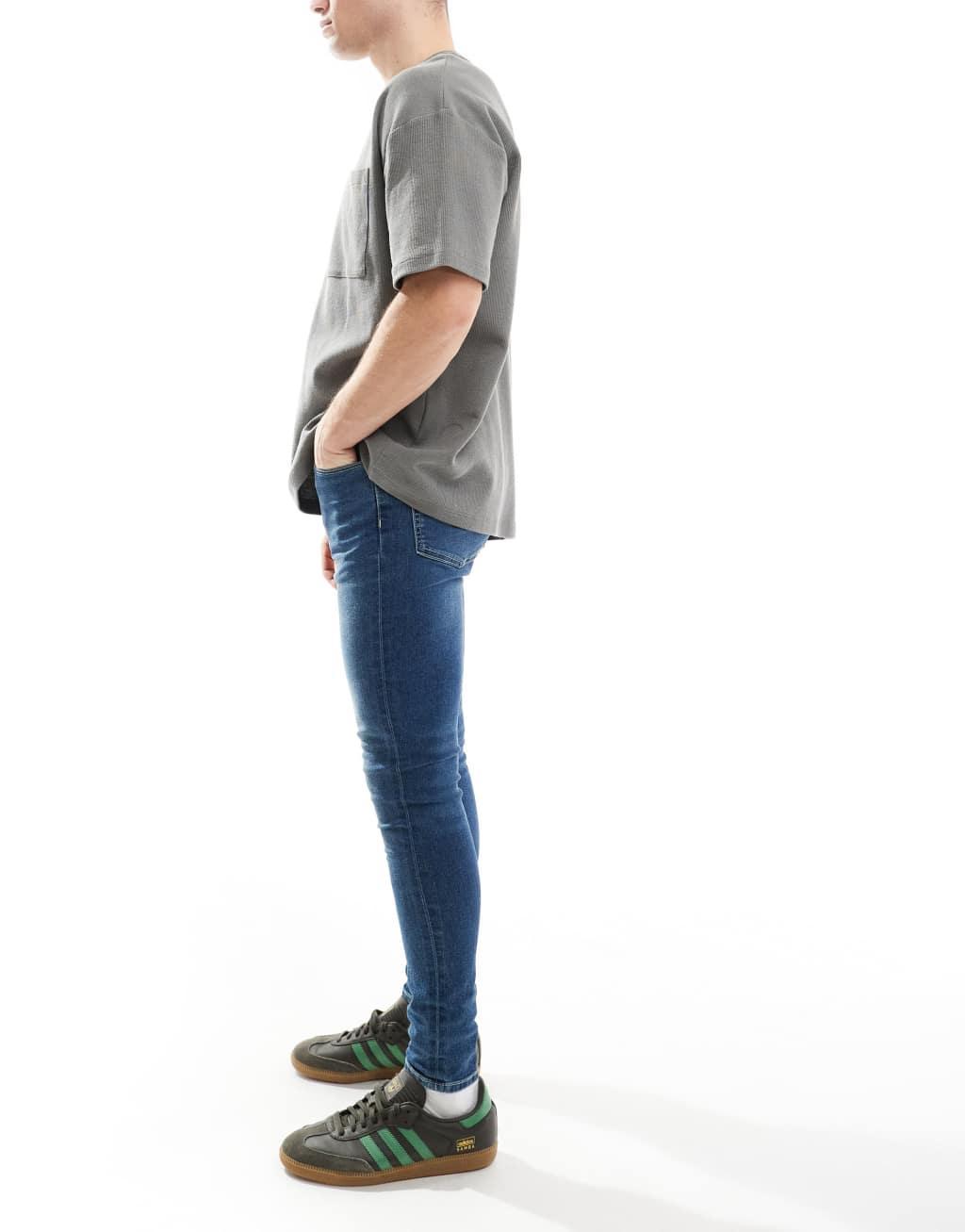 ASOS DESIGN power stretch jeans in dark wash blue Product Image
