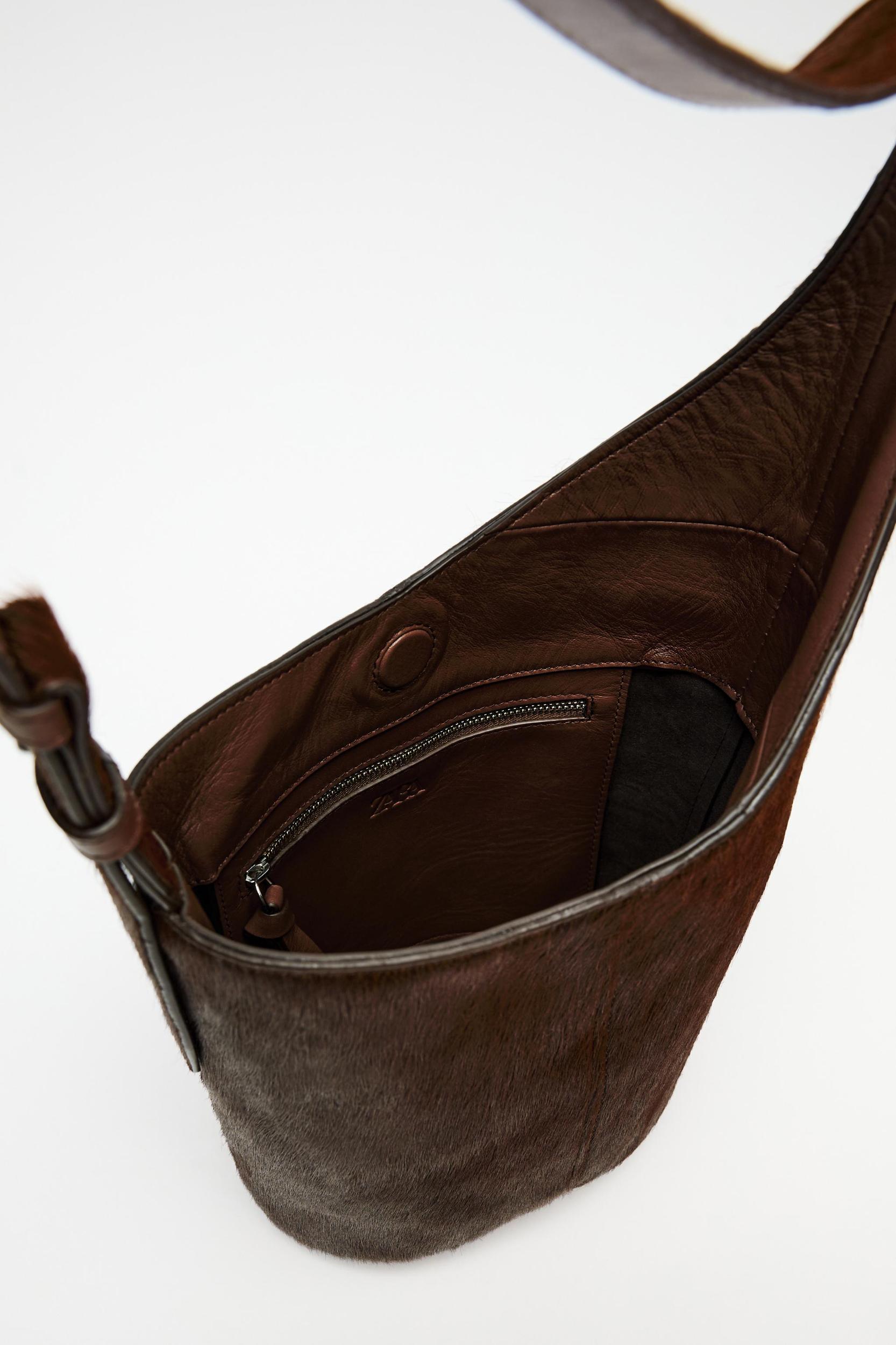 ASYMMETRIC FUR-TRIMMED LEATHER BUCKET BAG Product Image