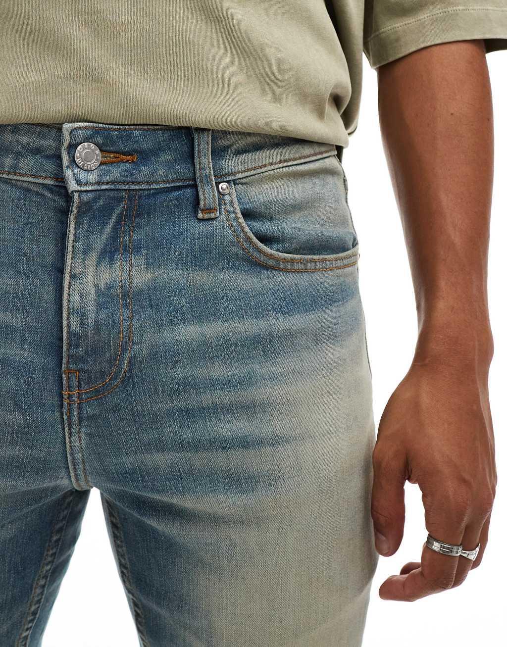 ASOS DESIGN skinny jeans with extreme tint in mid wash blue Product Image