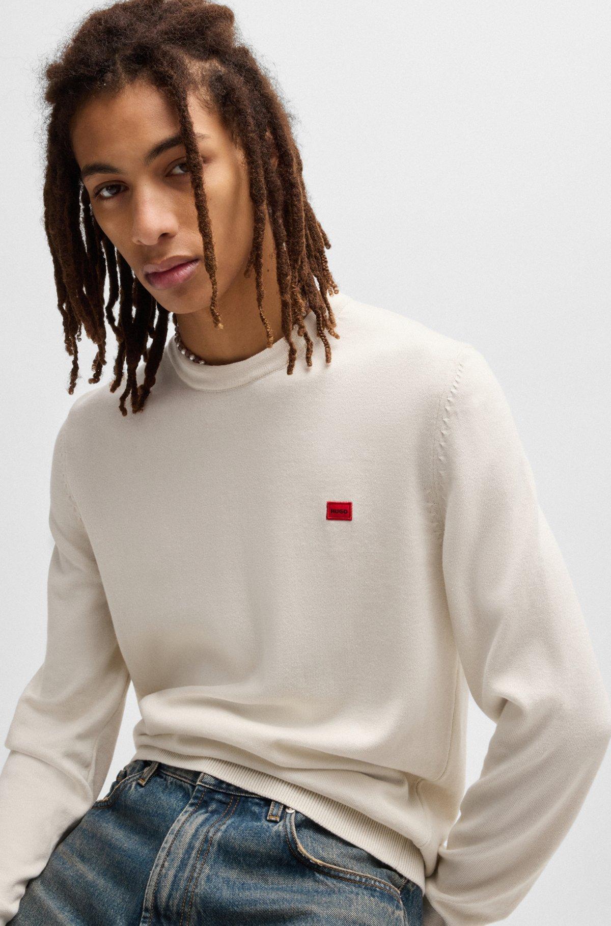 Knitted cotton sweater with red logo label Product Image