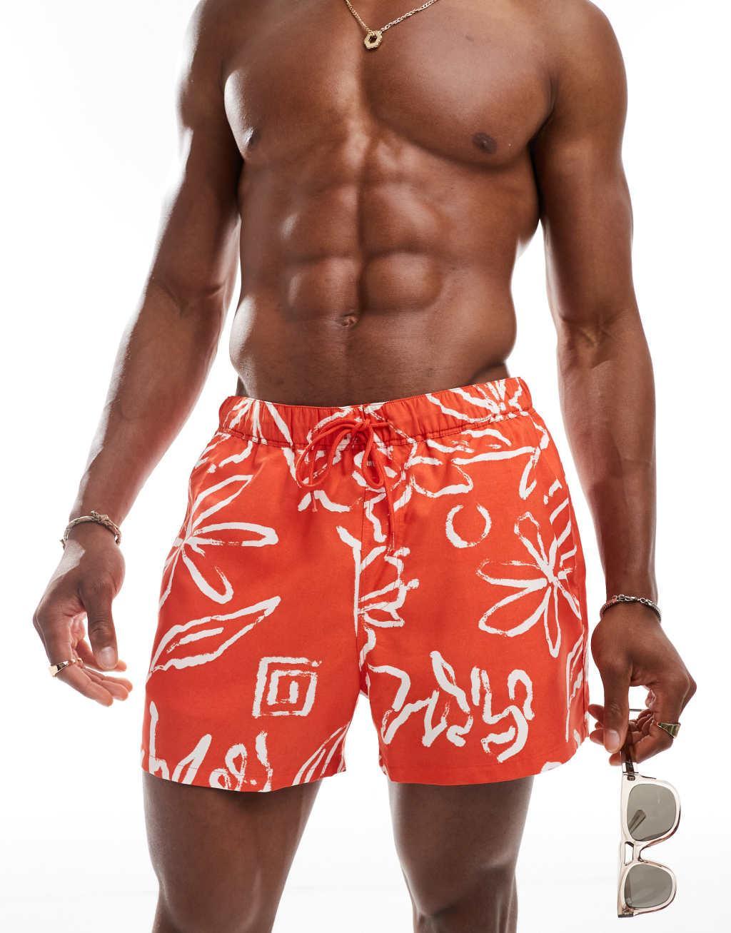 ASOS DESIGN swim shorts in short length in red floral print Product Image