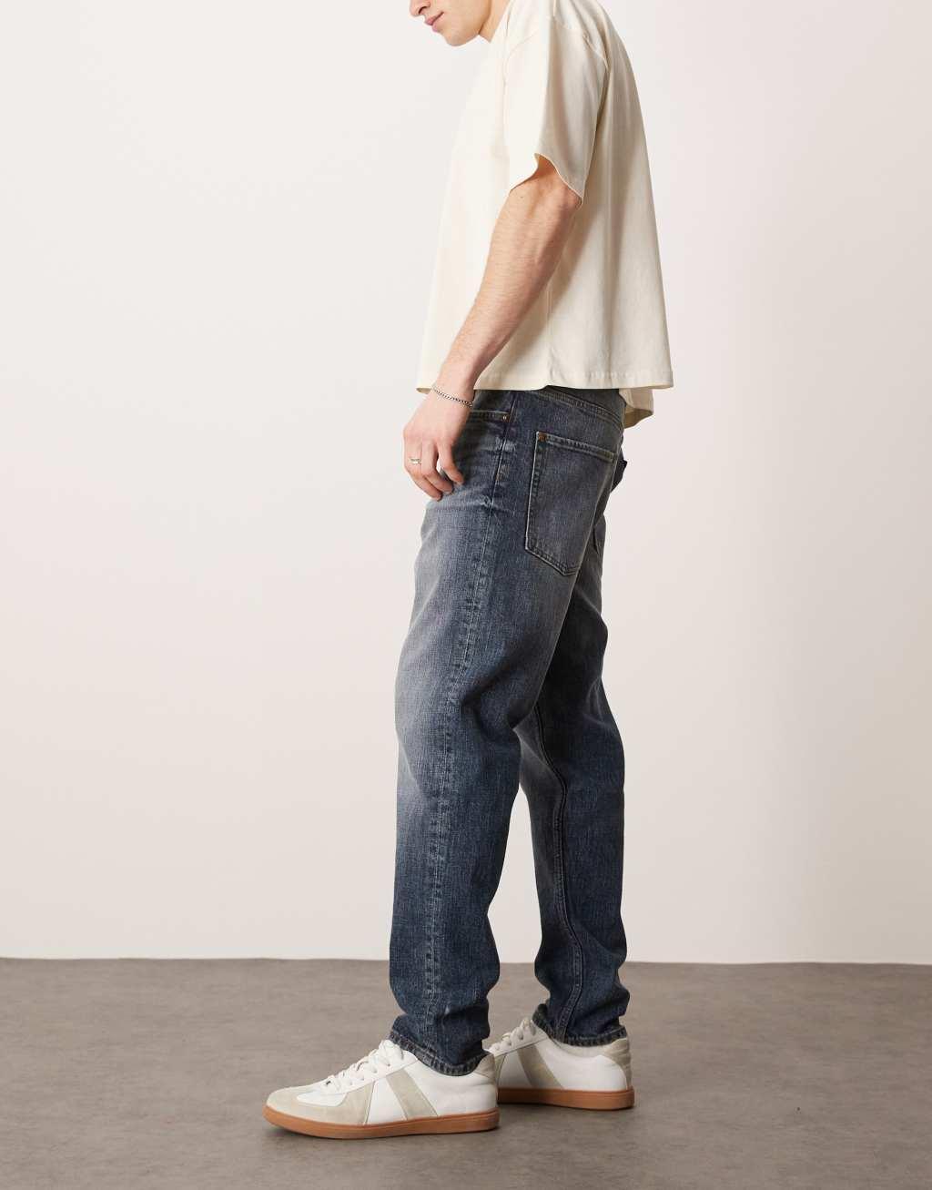ASOS DESIGN stretch tapered jeans in mid wash blue Product Image