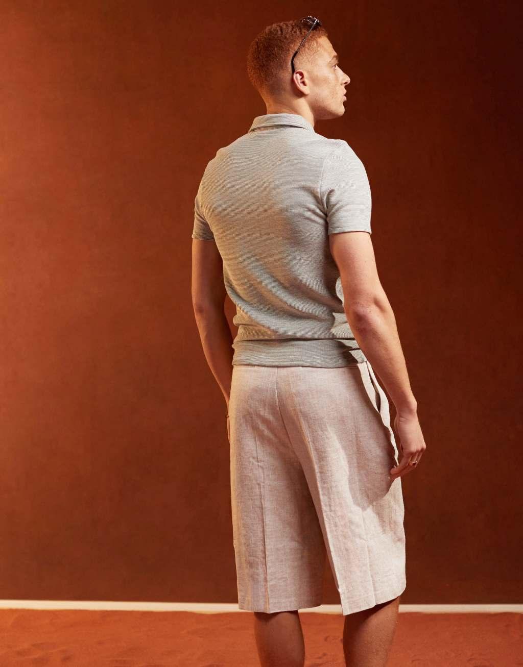 ASOS DESIGN muscle fit polo shirt with zip neck in textured beige Product Image