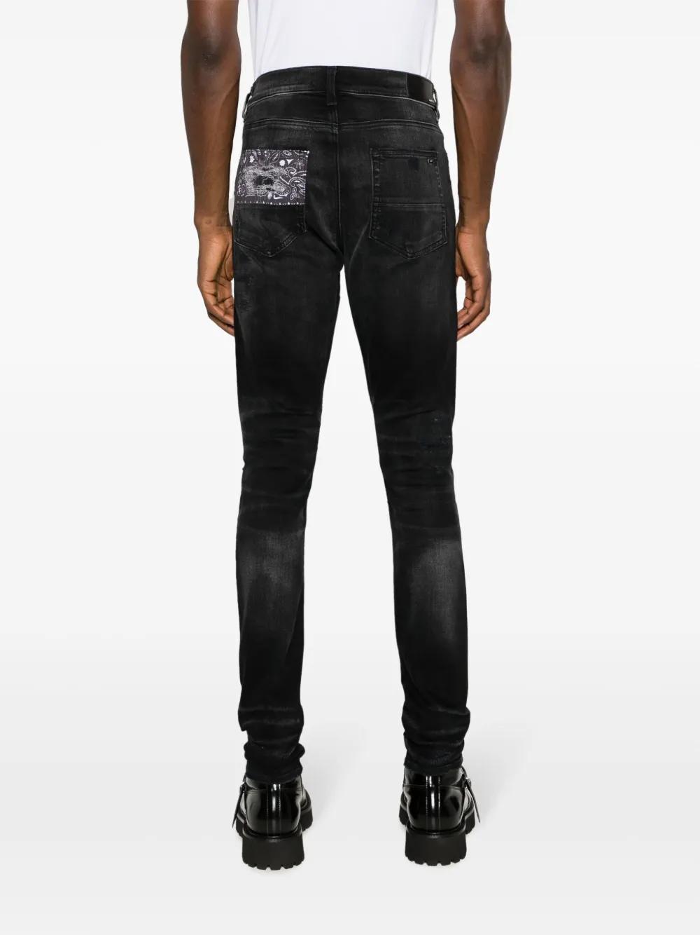 Artisanal distressed slim-fit jeans Product Image