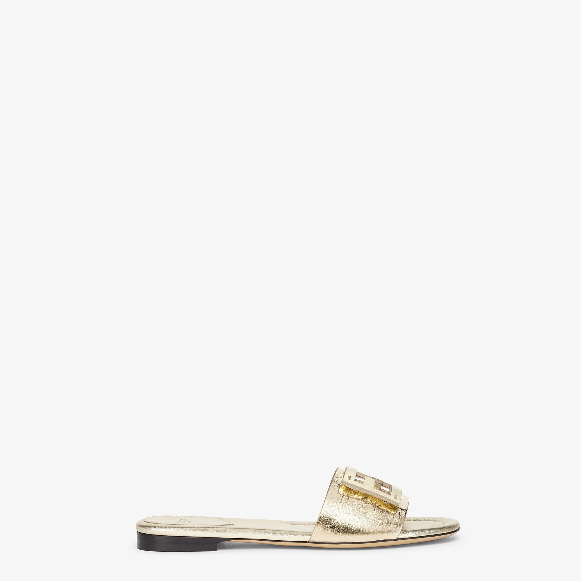 BaguetteMetallic champagne-colored leather slides Product Image