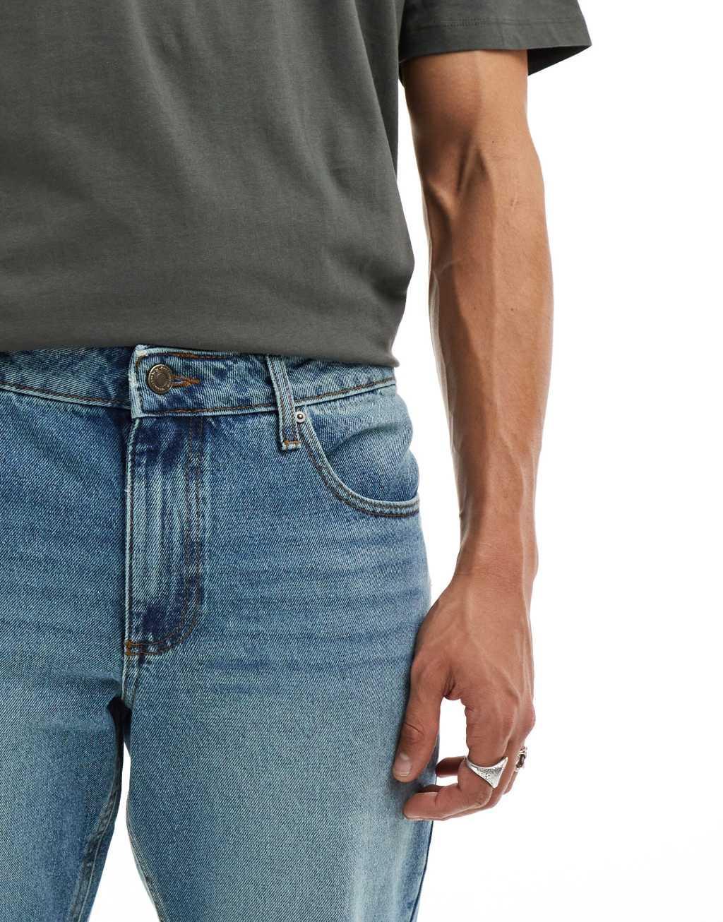 ASOS DESIGN tapered jeans in mid wash blue Product Image