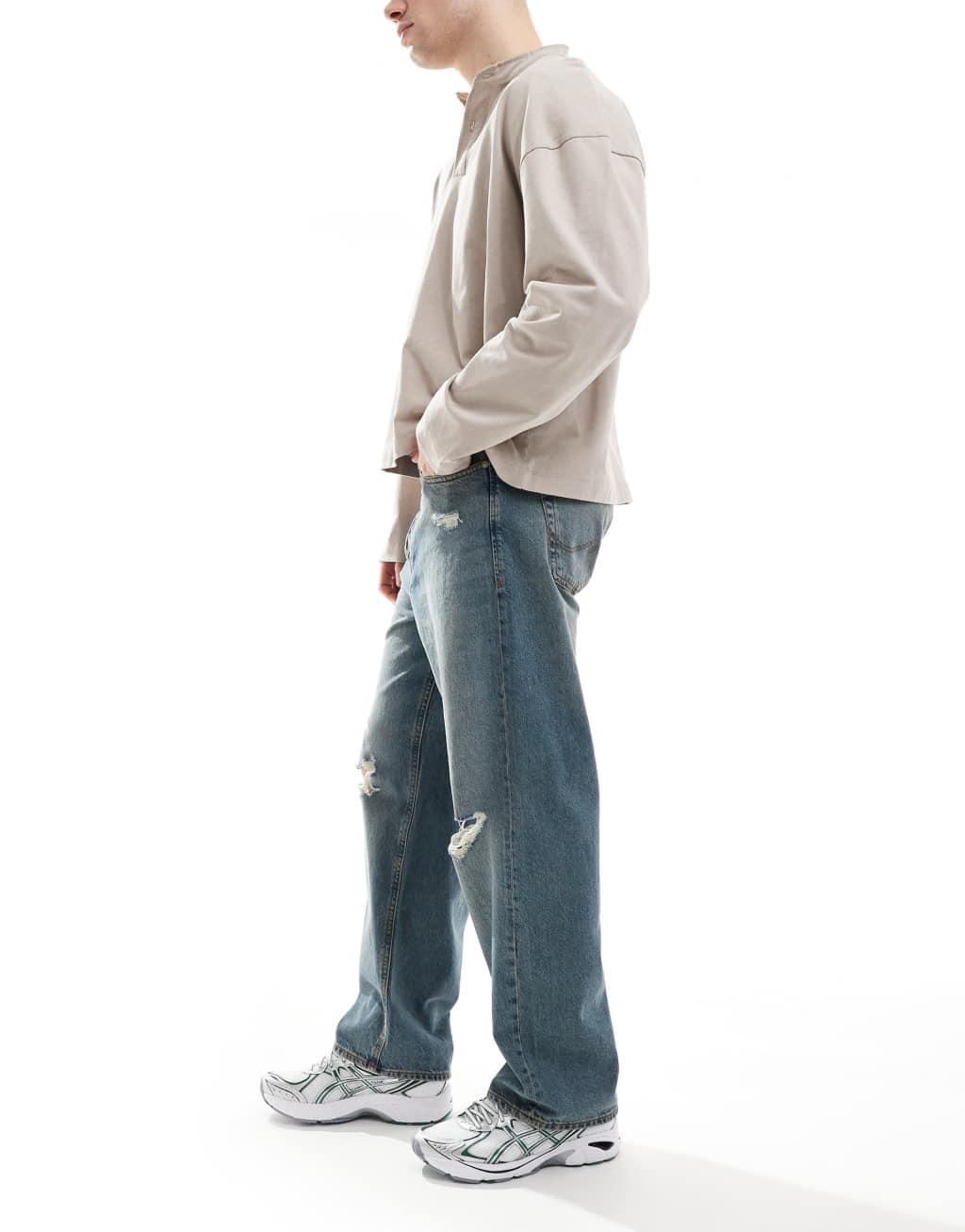 Jack & Jones Alex baggy fit jeans with knee rip in blue Product Image