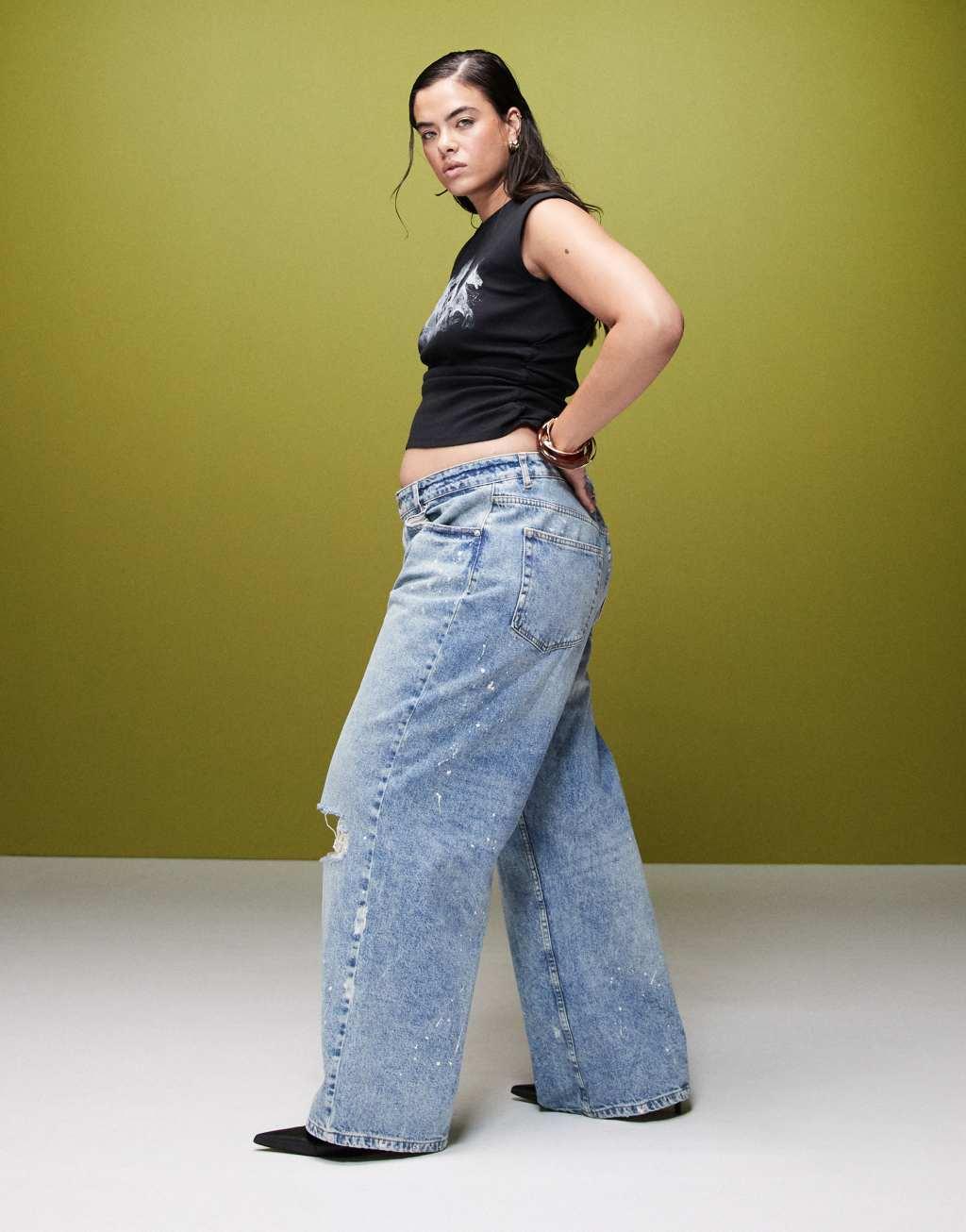 ASOS DESIGN Curve baggy jeans with rips and paint splats in mid blue Product Image
