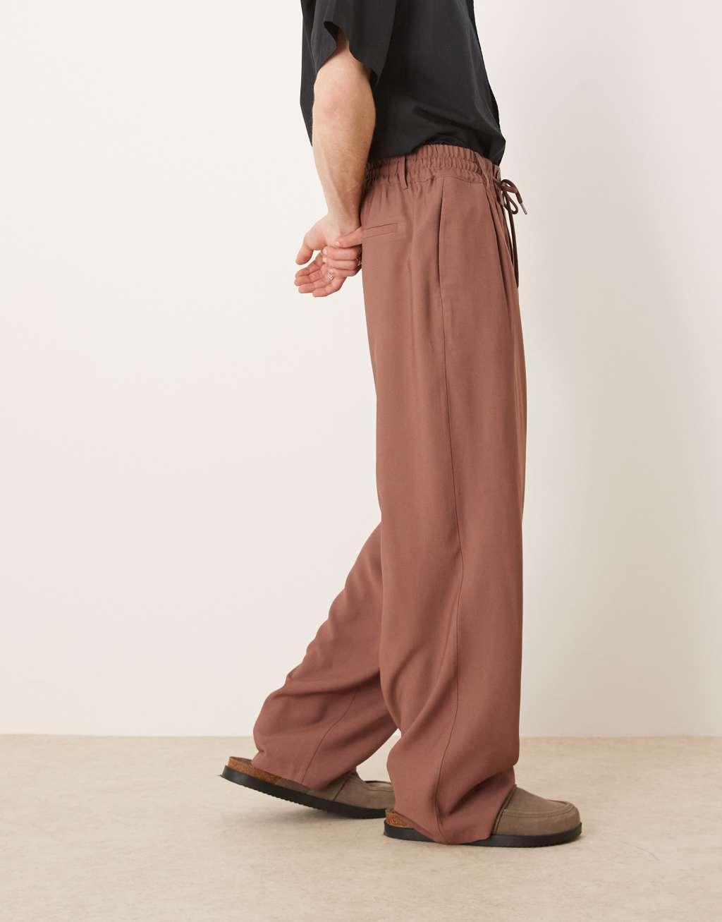 ASOS DESIGN loose fit smart pants with wide waistband and elasticated waist in brown Product Image