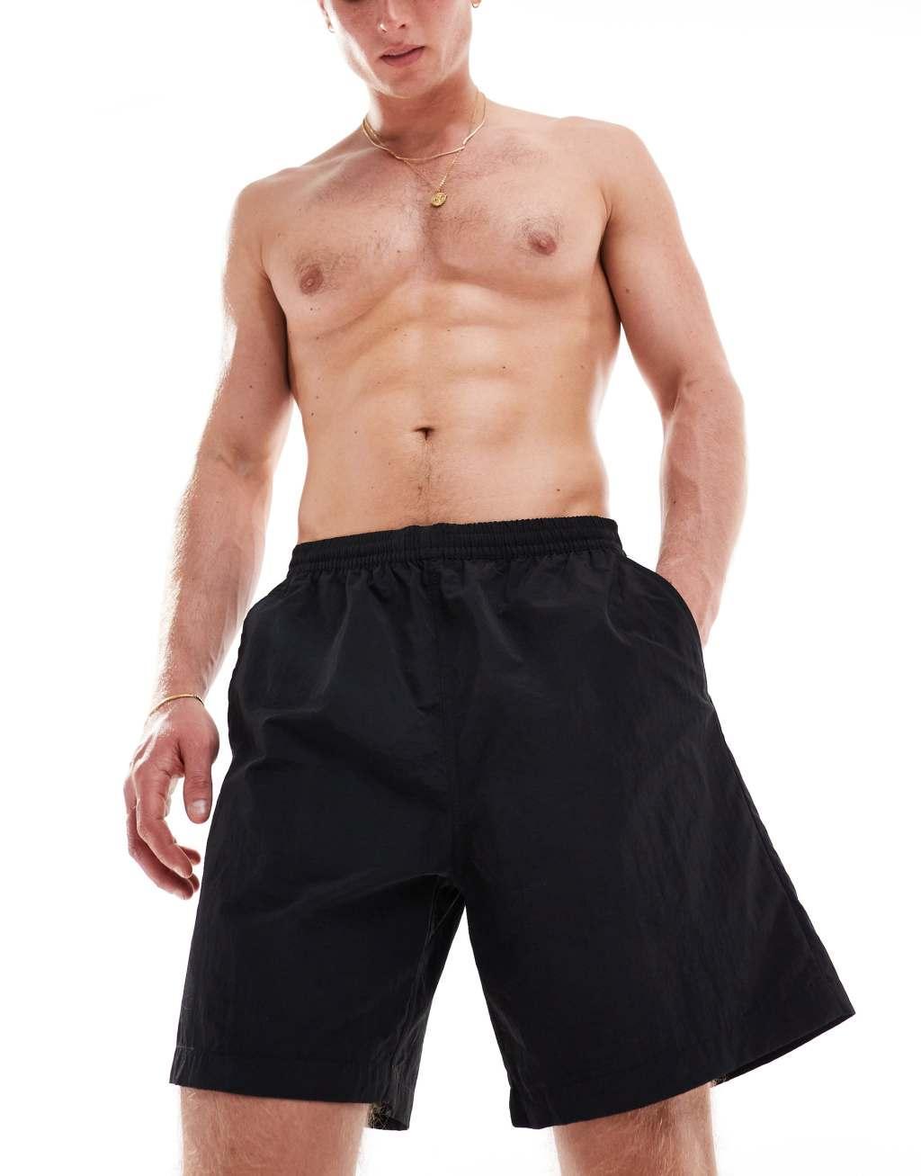 Weekday Ed skater style swim shorts in black Product Image