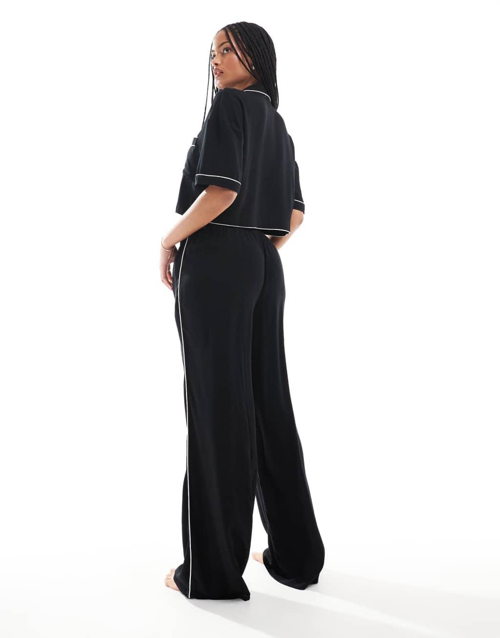 ASOS DESIGN Tall super soft slinky wide leg pajama pants in black with contrast binding Product Image
