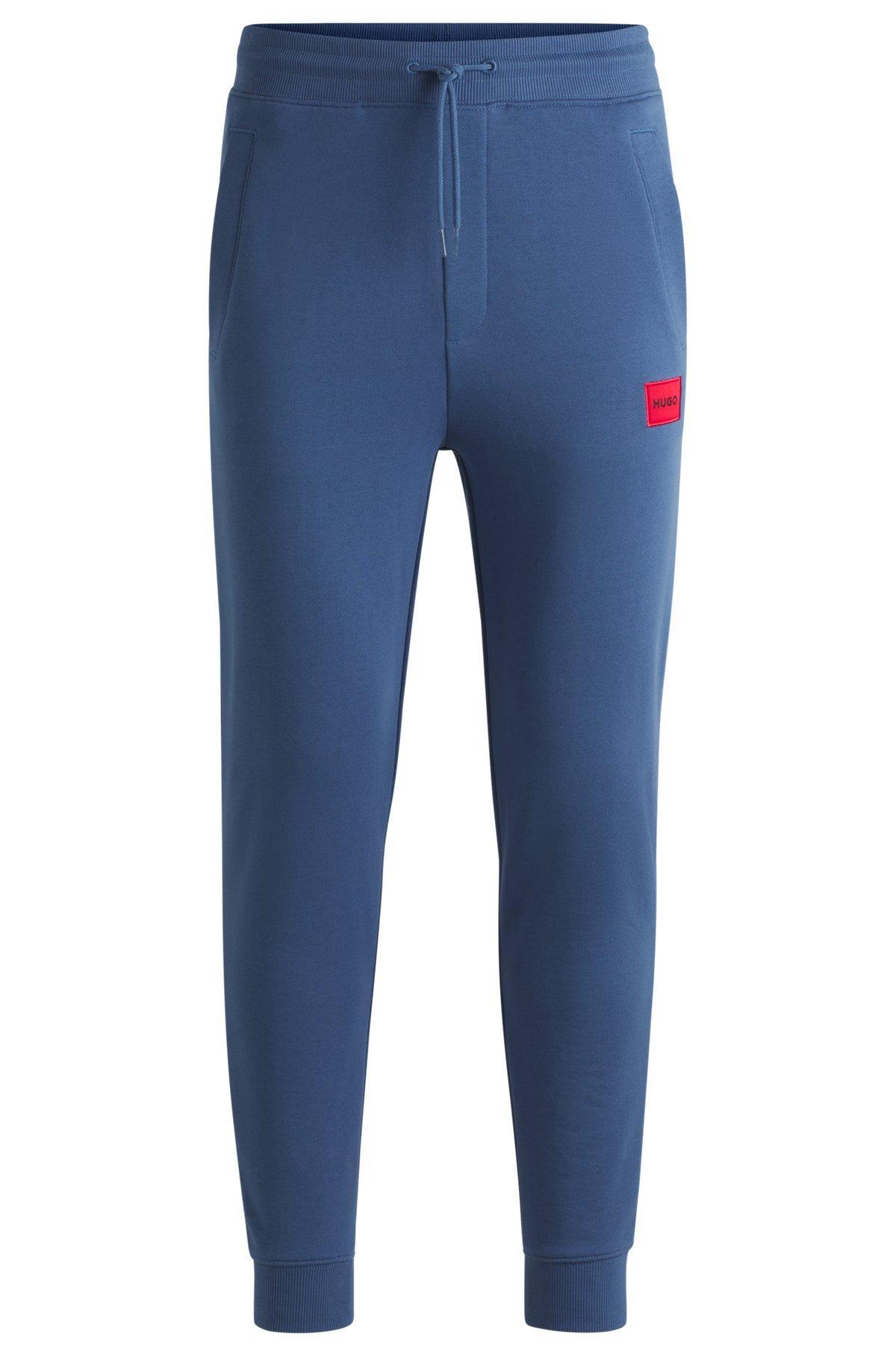 Cotton-terry tracksuit bottoms with logo label Product Image