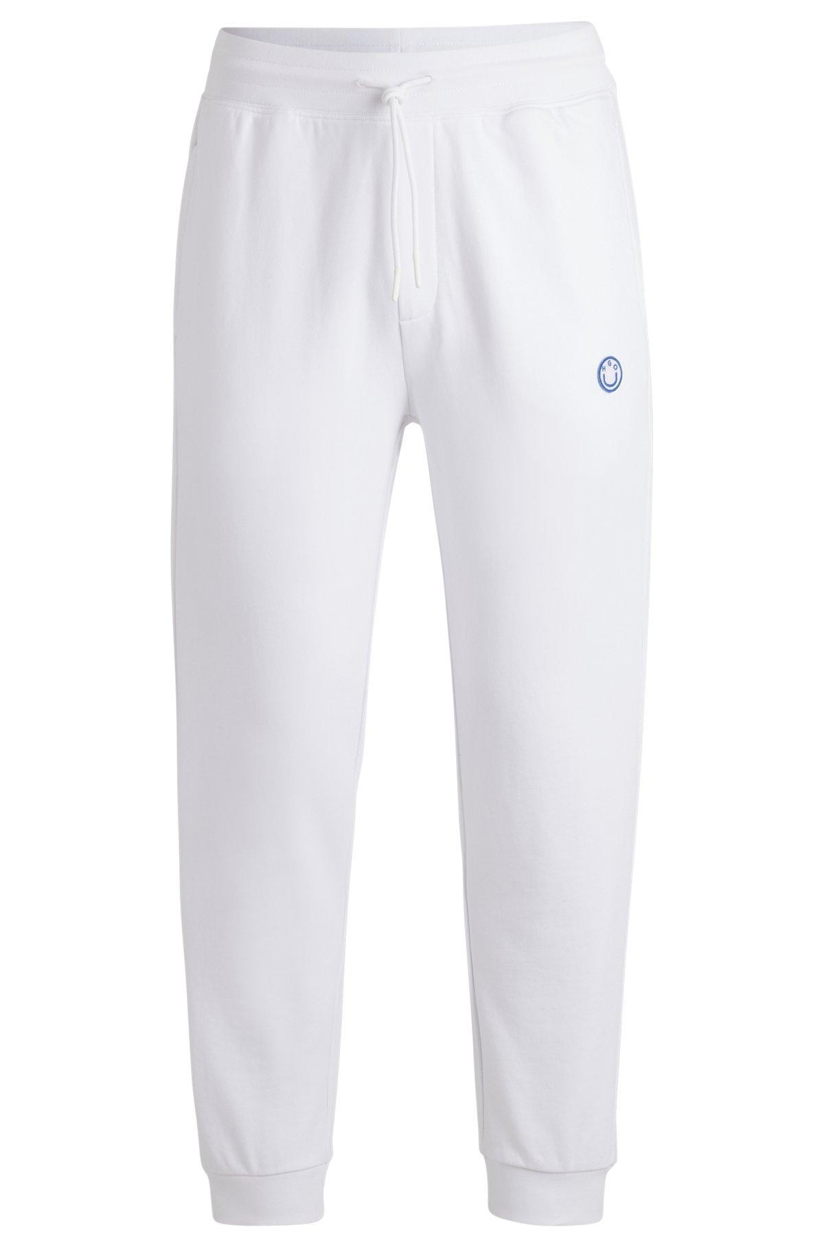 Cotton-terry tracksuit bottoms with Happy HUGO logo Product Image