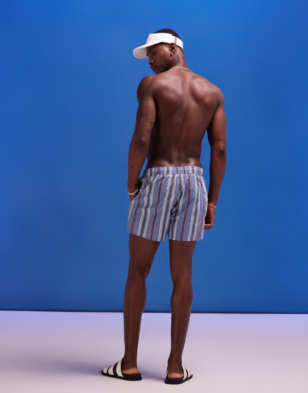 ASOS DESIGN swim shorts in mid length in blue acid wash Product Image
