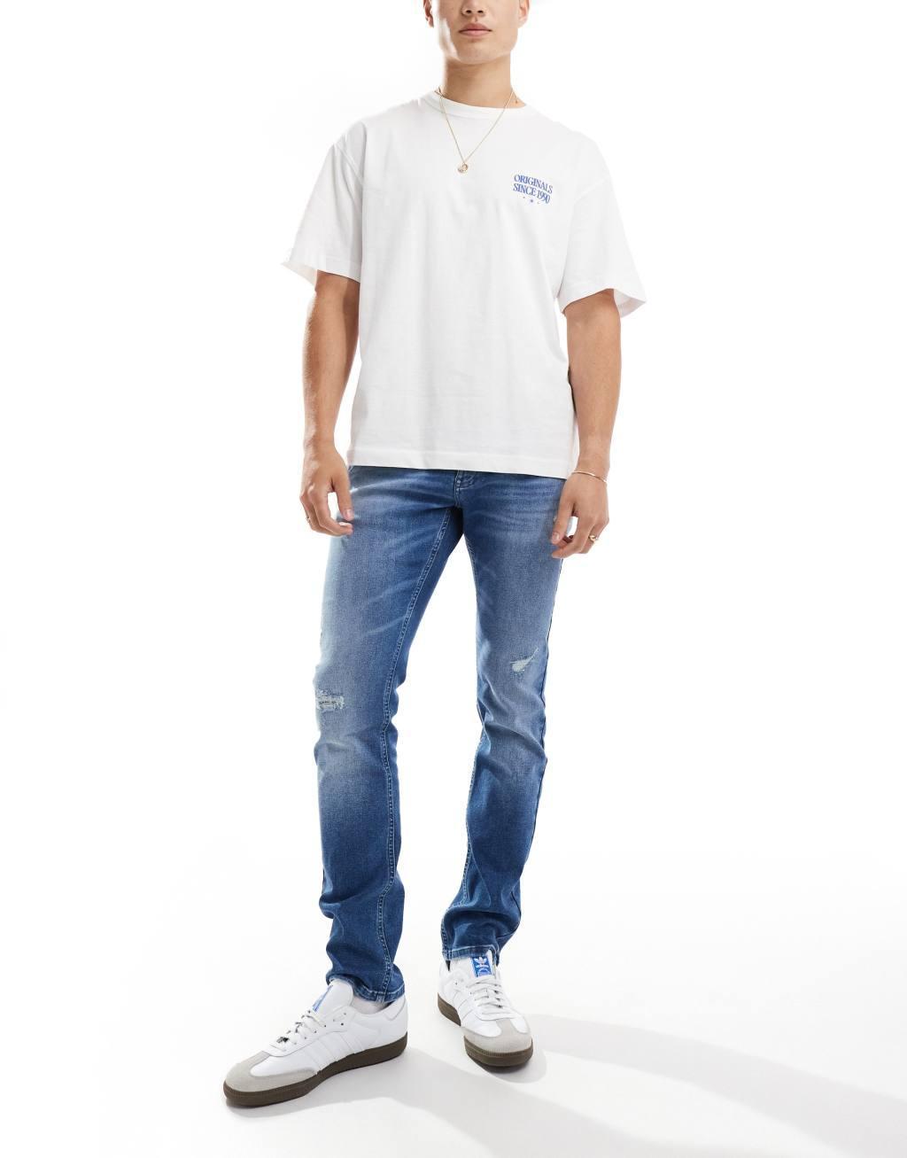 Tommy Jeans Scanton slim ripped jeans in mid wash Product Image