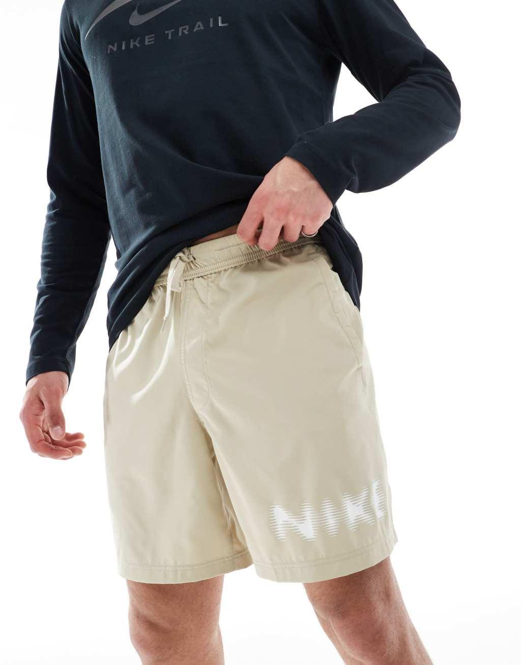 Nike Training blurred swoosh graphic 7 inch shorts in beige Product Image