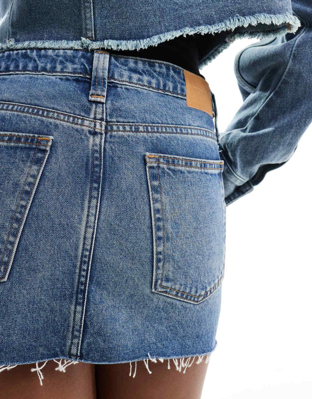 Monki low waist denim mini skirt in mid blue wash  Product Image