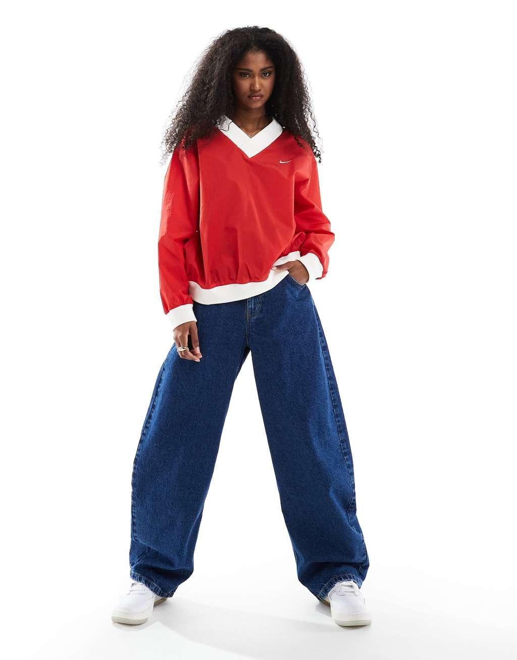 Nike Essential woven v-neck sweatshirt in red Product Image