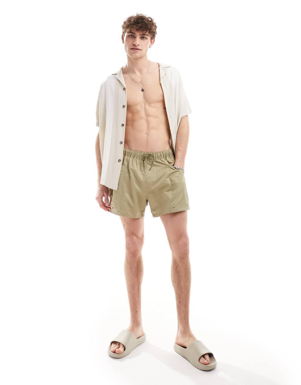 ASOS DESIGN swim shorts in short length with cargo pockets in green  Product Image