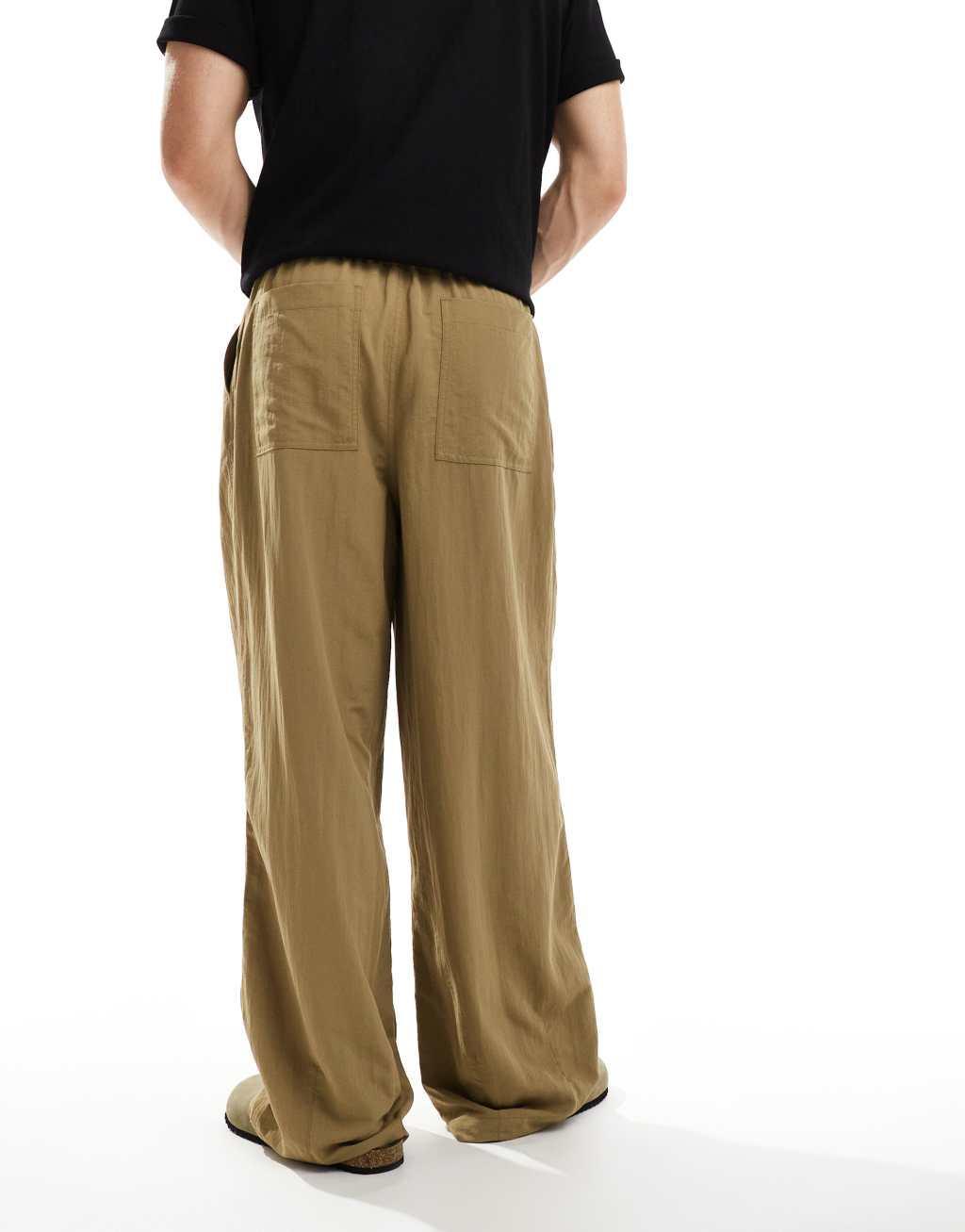 ASOS DESIGN oversized baggy chinos with pleats in khaki  Product Image