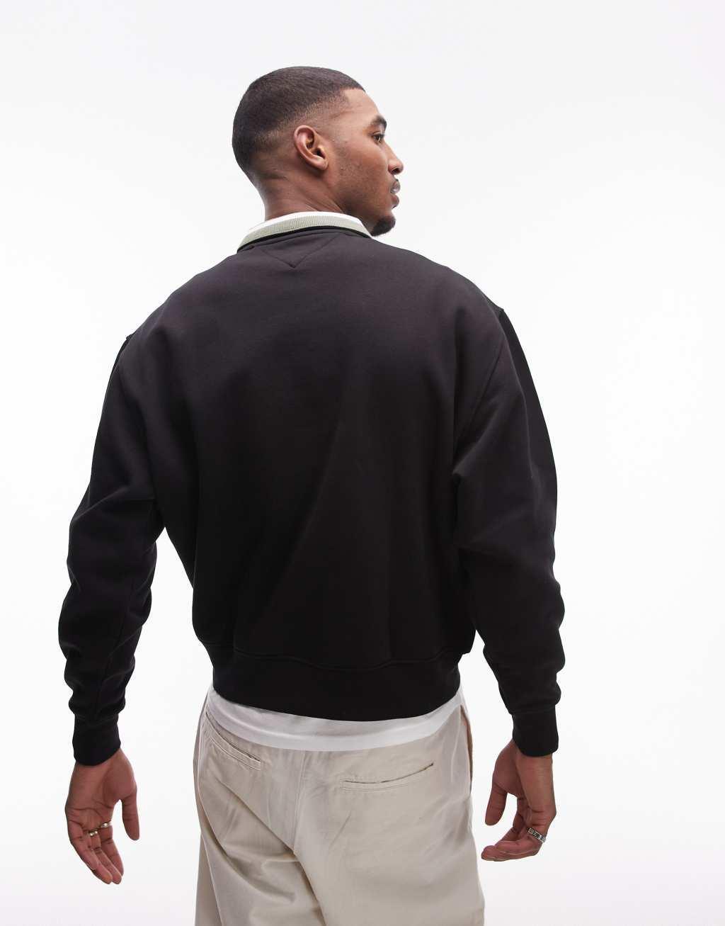 Tommy Jeans linear logo half zip sweatshirt in black Product Image