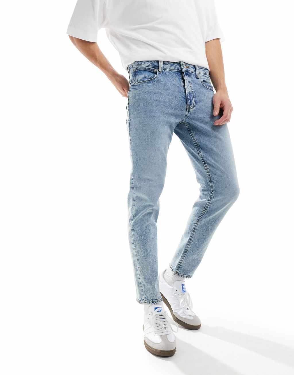 ASOS DESIGN stretch tapered jeans in light wash blue Product Image