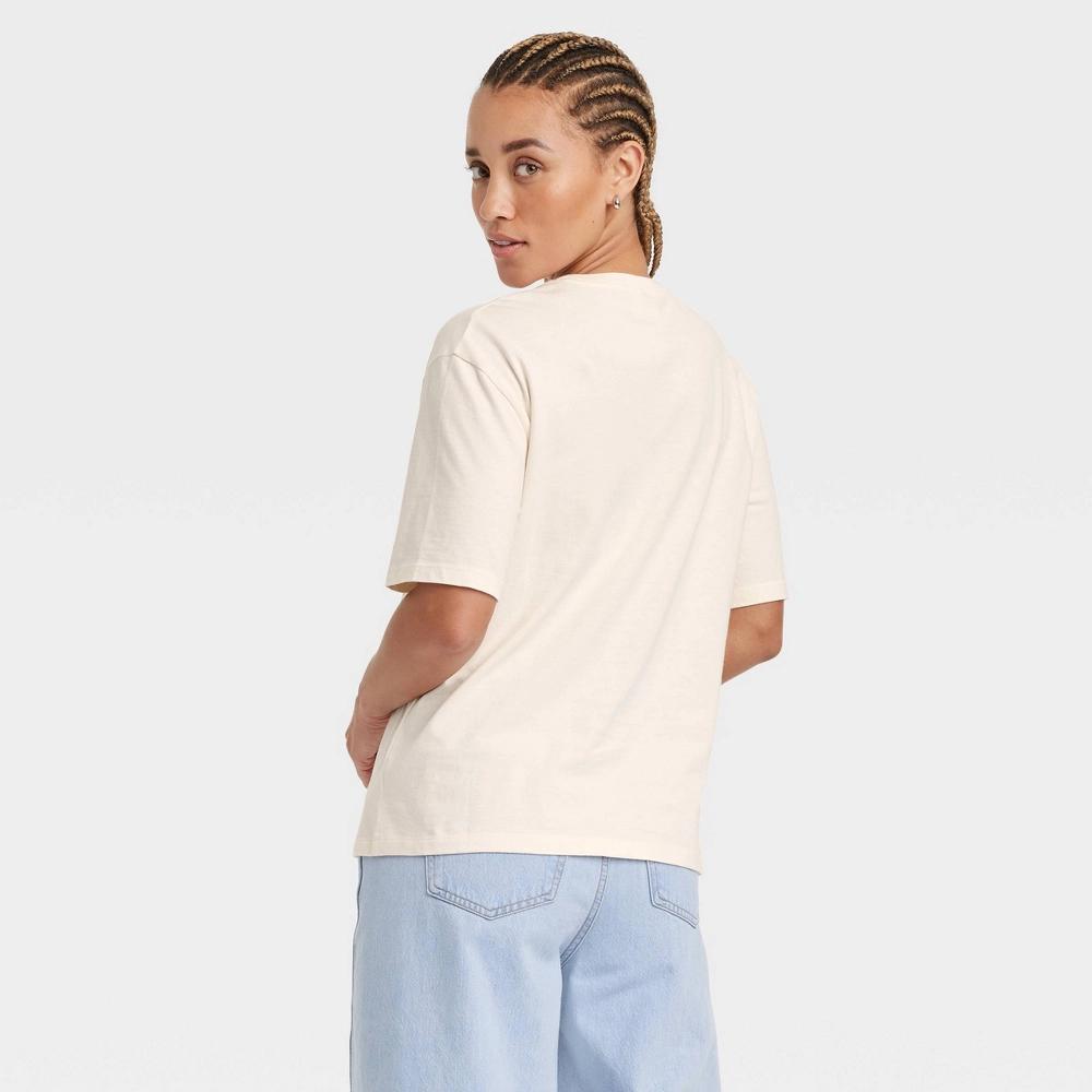 Women's Oversized Short Sleeve Knit Graphic T-Shirt - Universal Thread™ Cream S: 100% Cotton, Midweight Knit Jersey, Crew Neck Pullover Product Image