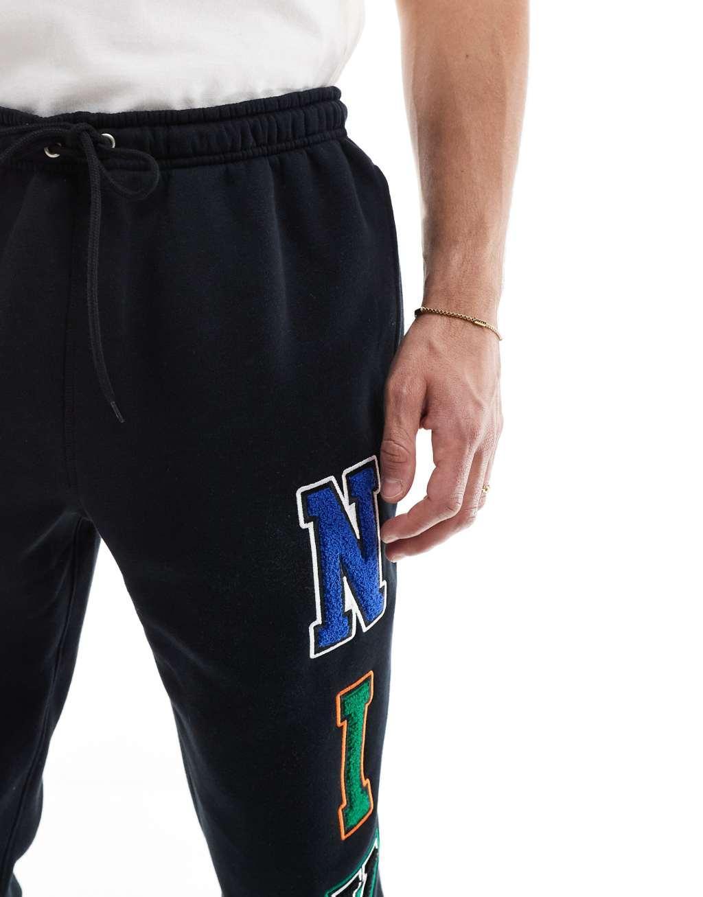 Nike Club chenille logo sweatpants in black Product Image