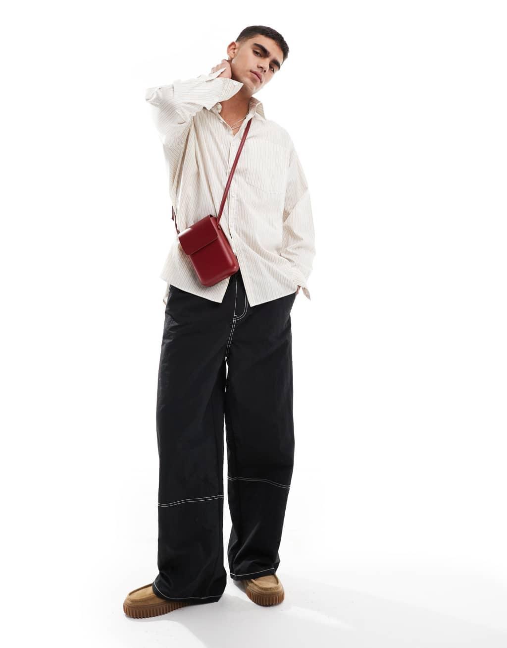 ASOS DESIGN baggy pants in black nylon with contrast stitch Product Image