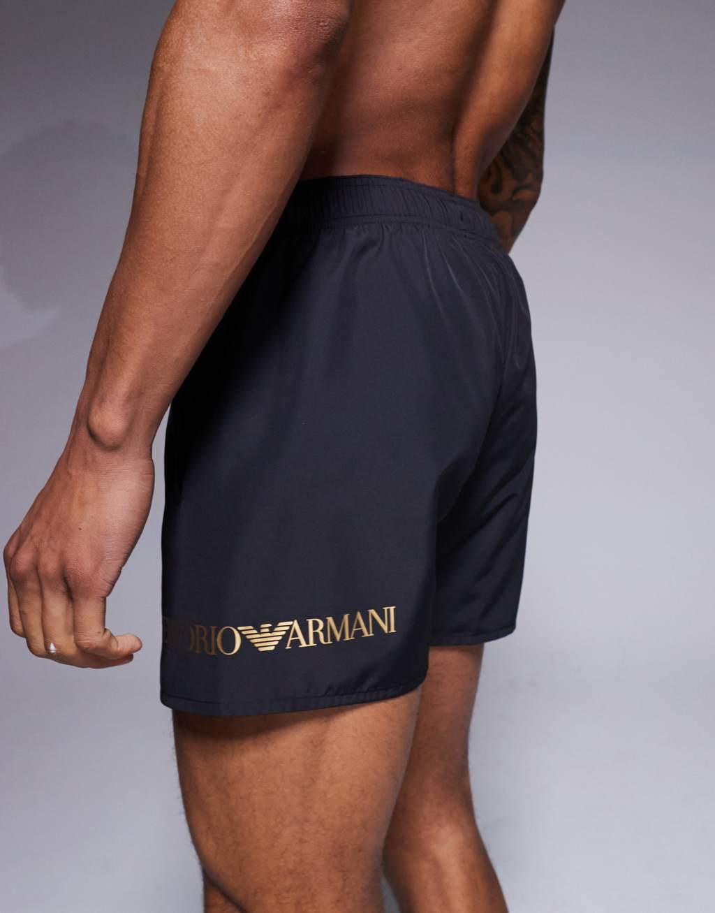 Armani EA7 gold logo swim shorts in black Product Image