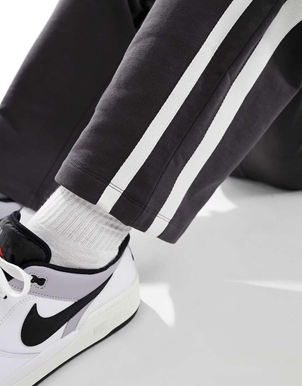 ASOS DESIGN tape stripe wide leg sweatpants in black Product Image