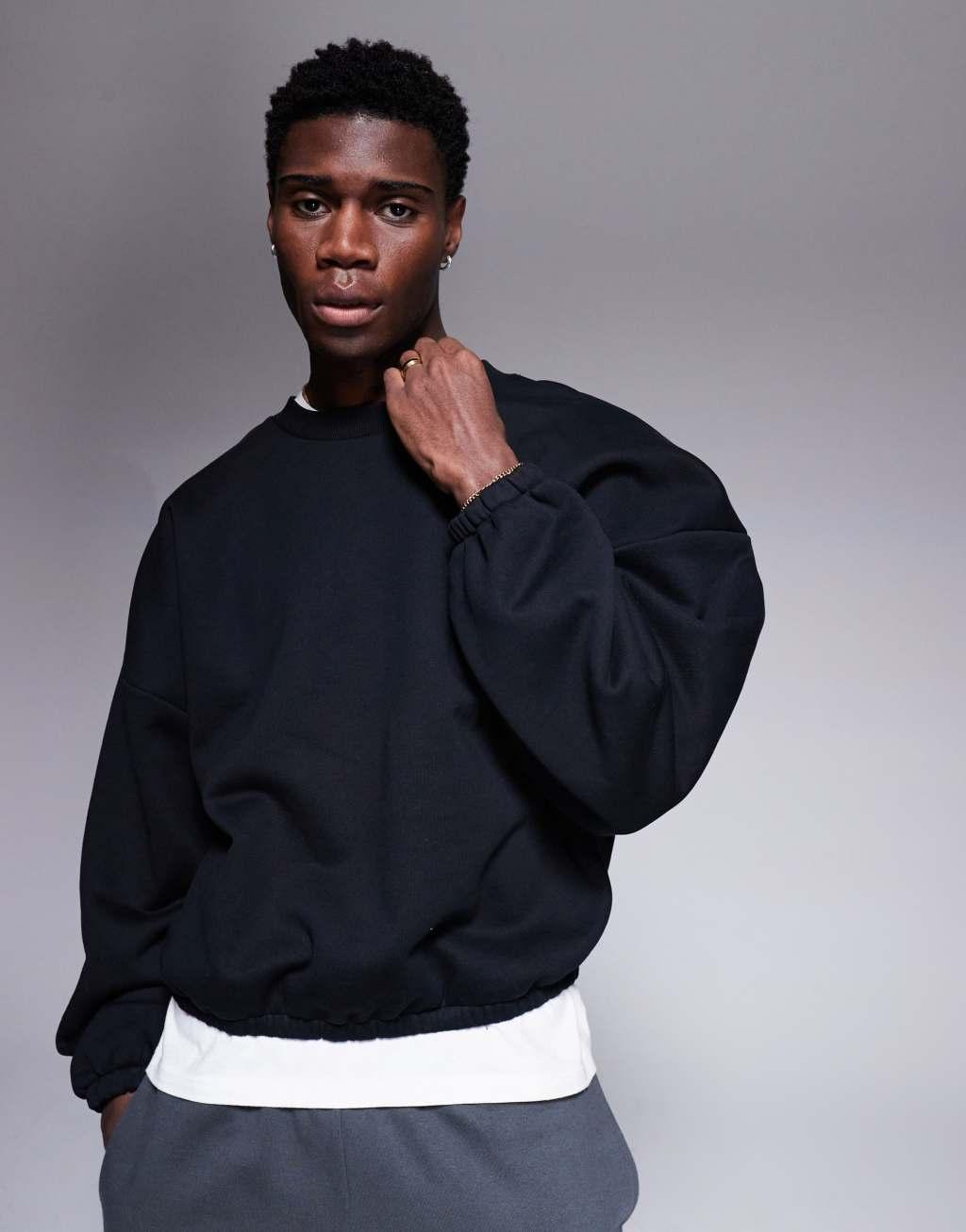 ASOS DESIGN heavyweight boxy extreme oversized sweatshirt with elasticized cuffs and hem in black Product Image