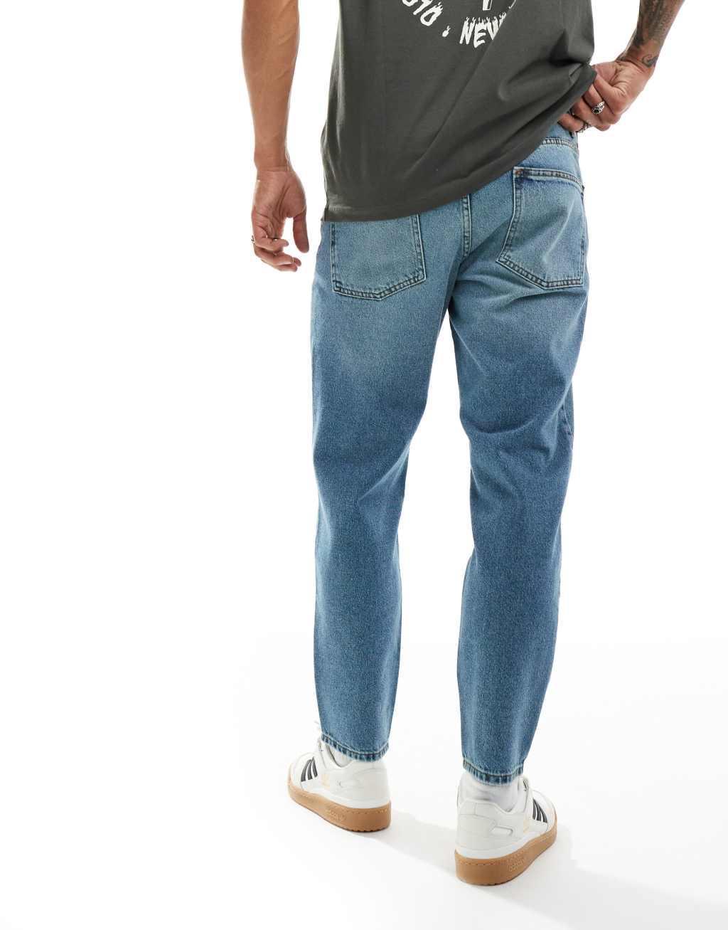 ASOS DESIGN tapered jeans in mid wash blue Product Image