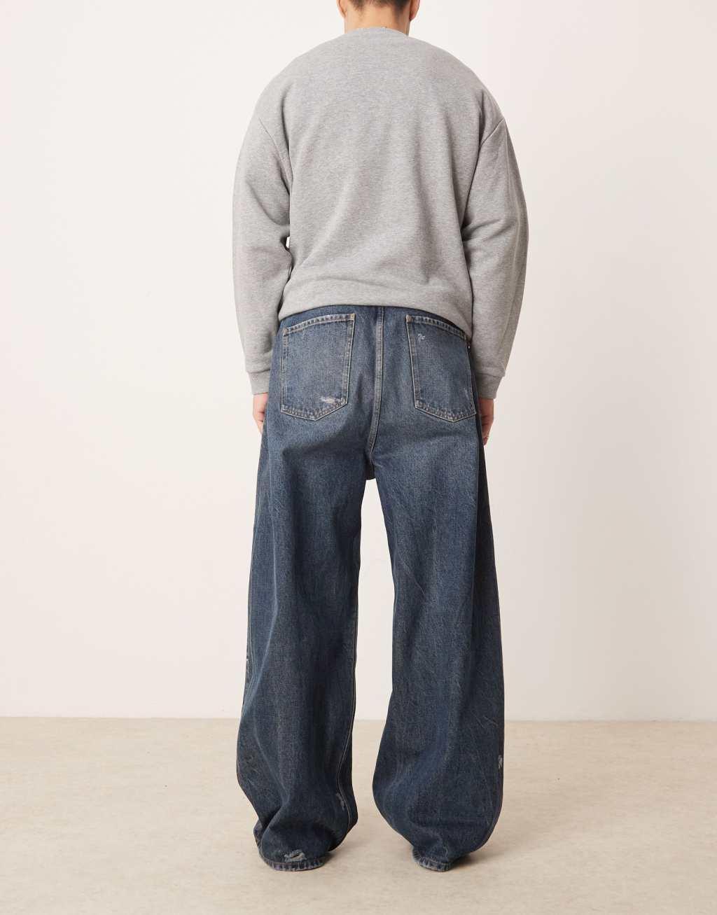 ASOS DESIGN skater fit jeans in dark wash blue with rips Product Image