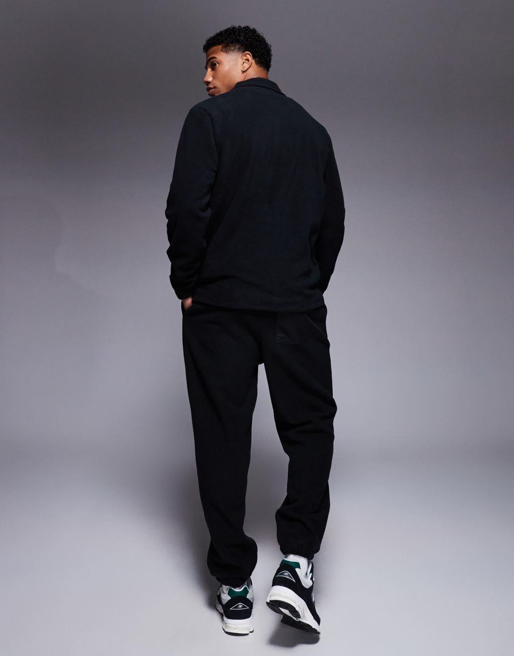 ASOS DESIGN tapered fleece sweatpants in black Product Image