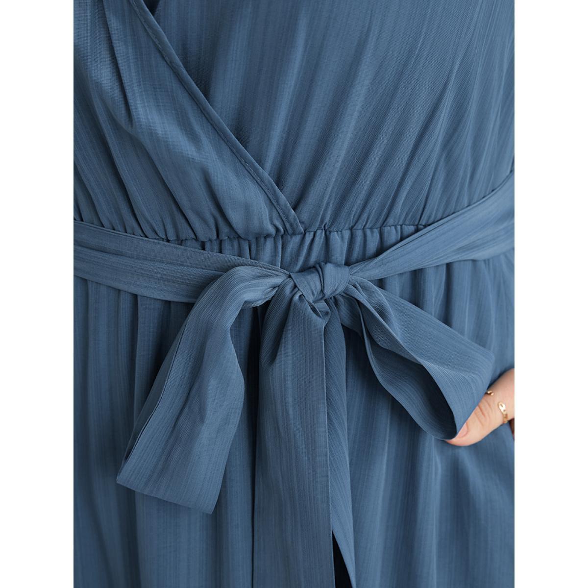 Plus Size Solid Surplice Neck Lantern Sleeve Pocket Belted Asymmetrical Hem Dress Cerulean Women Elegant Asymmetrical V-neck Long Sleeve Curvy Midi Dress BloomChic 22-24/3X Product Image