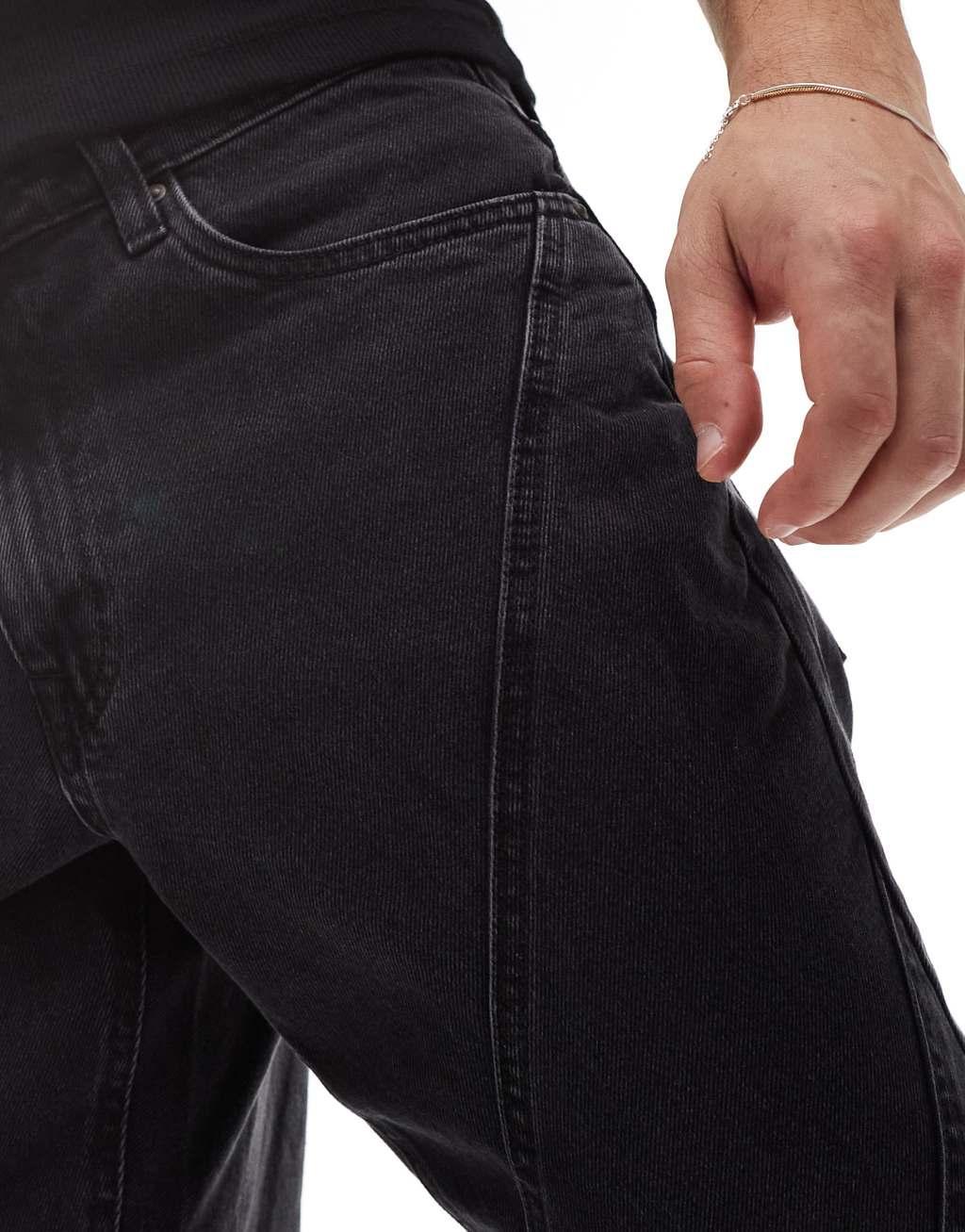 ASOS DESIGN tapered fit jeans with paneling detail in washed black Product Image