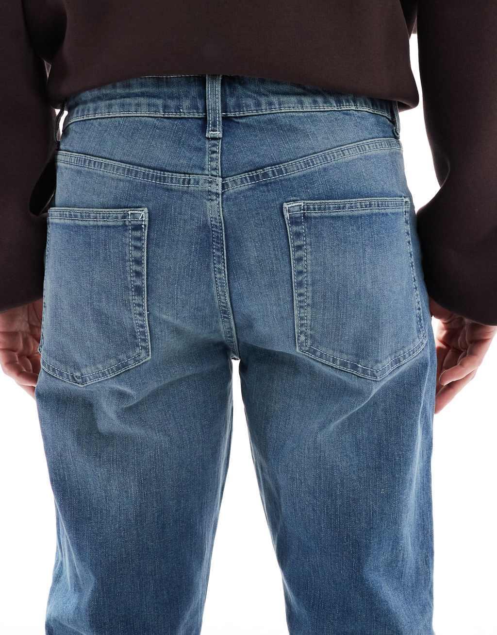 ASOS DESIGN skinny jeans with green tint in dark wash blue Product Image