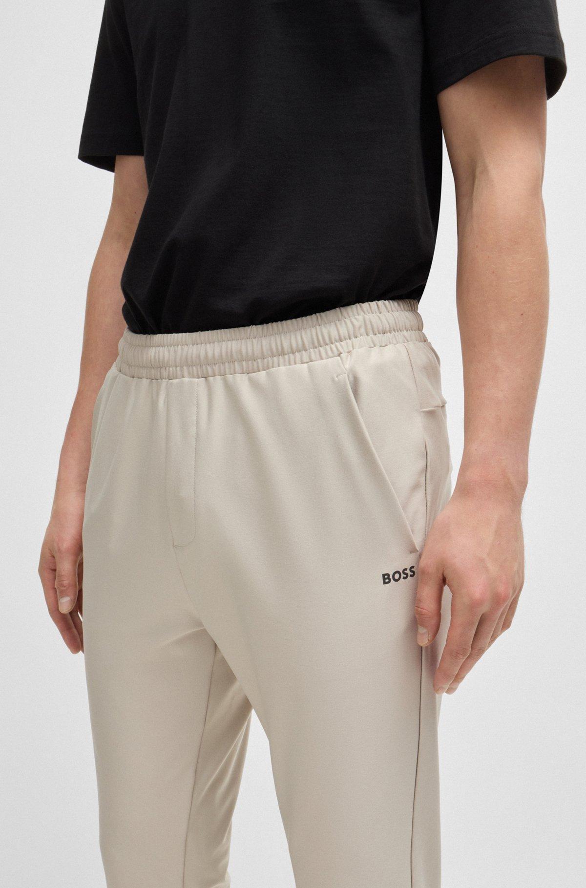 Tracksuit bottoms in stretch fabric with decorative reflective logo Product Image
