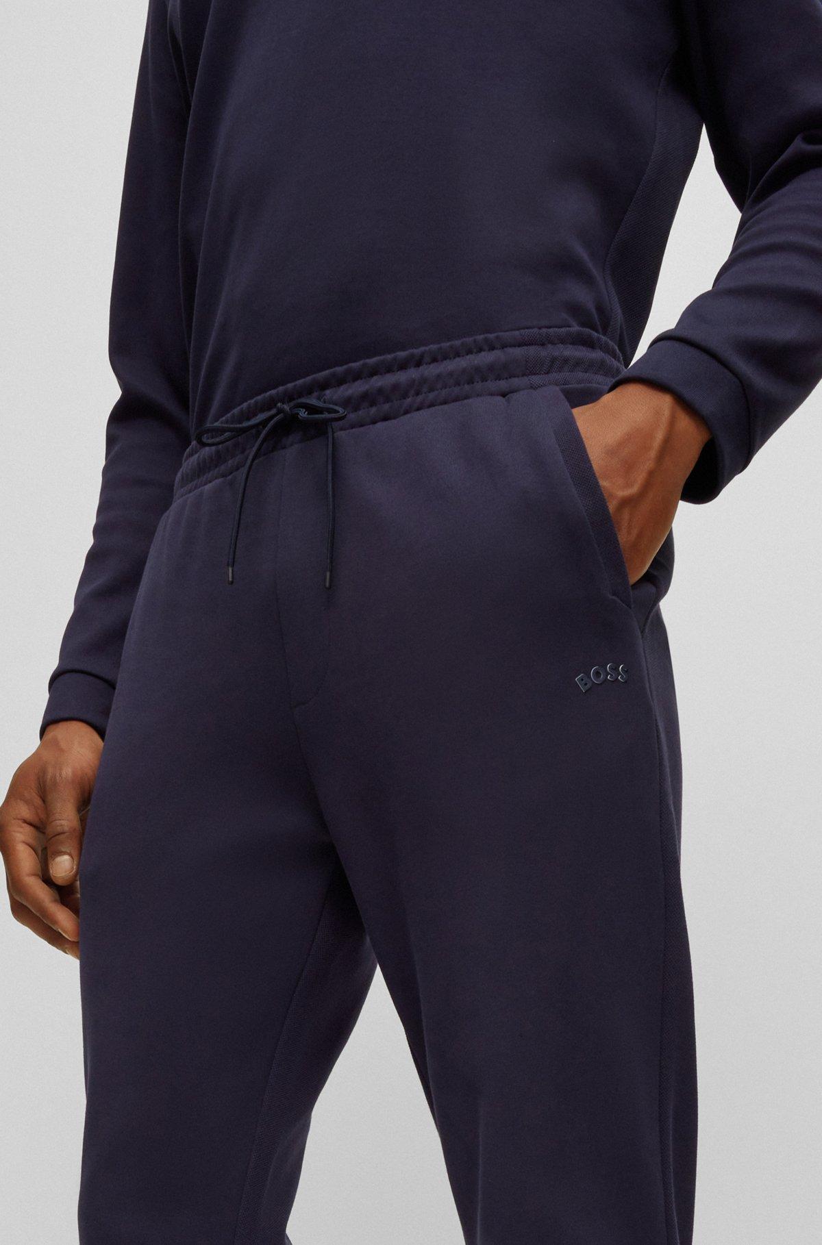 Cotton tracksuit bottoms with curved logo Product Image